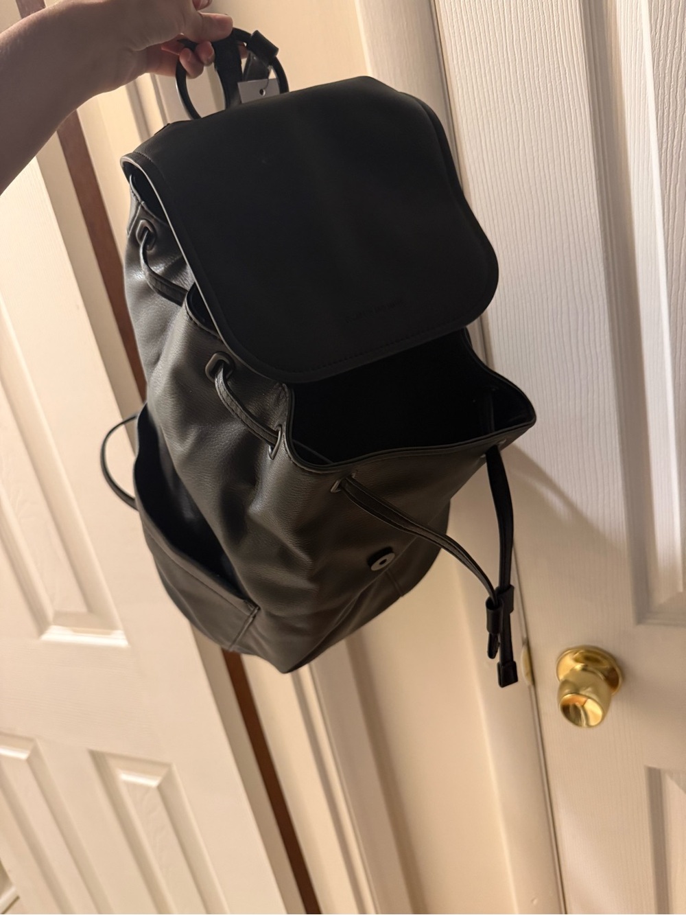 Elizabeth and James Black Leather Backpack with Drawstring Flap